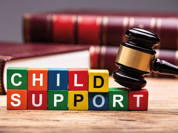 A wooden gavel with the word child support on it.