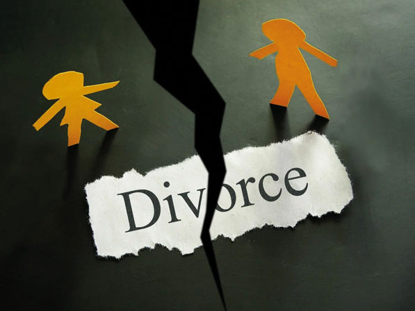 A broken piece of paper with the word divorce on it.